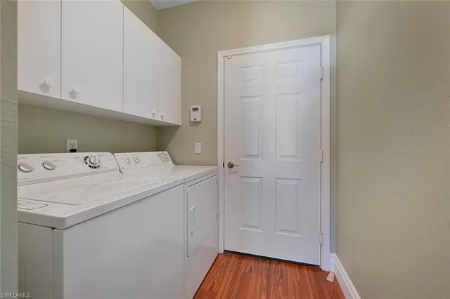 a utility room with a sink dryer and washer