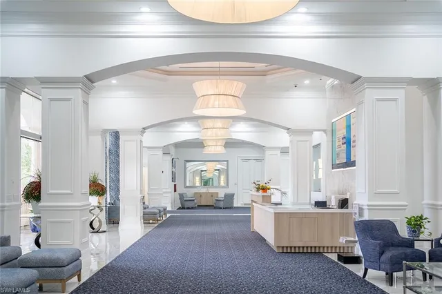 a living room with furniture and a chandelier