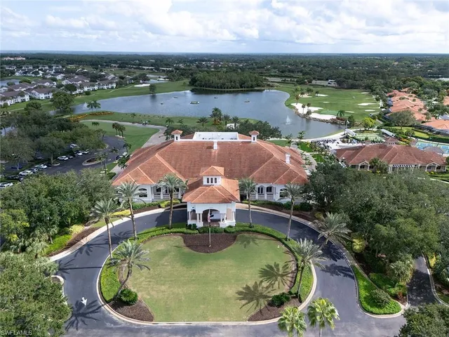 an aerial view of residential houses with outdoor space and lake view