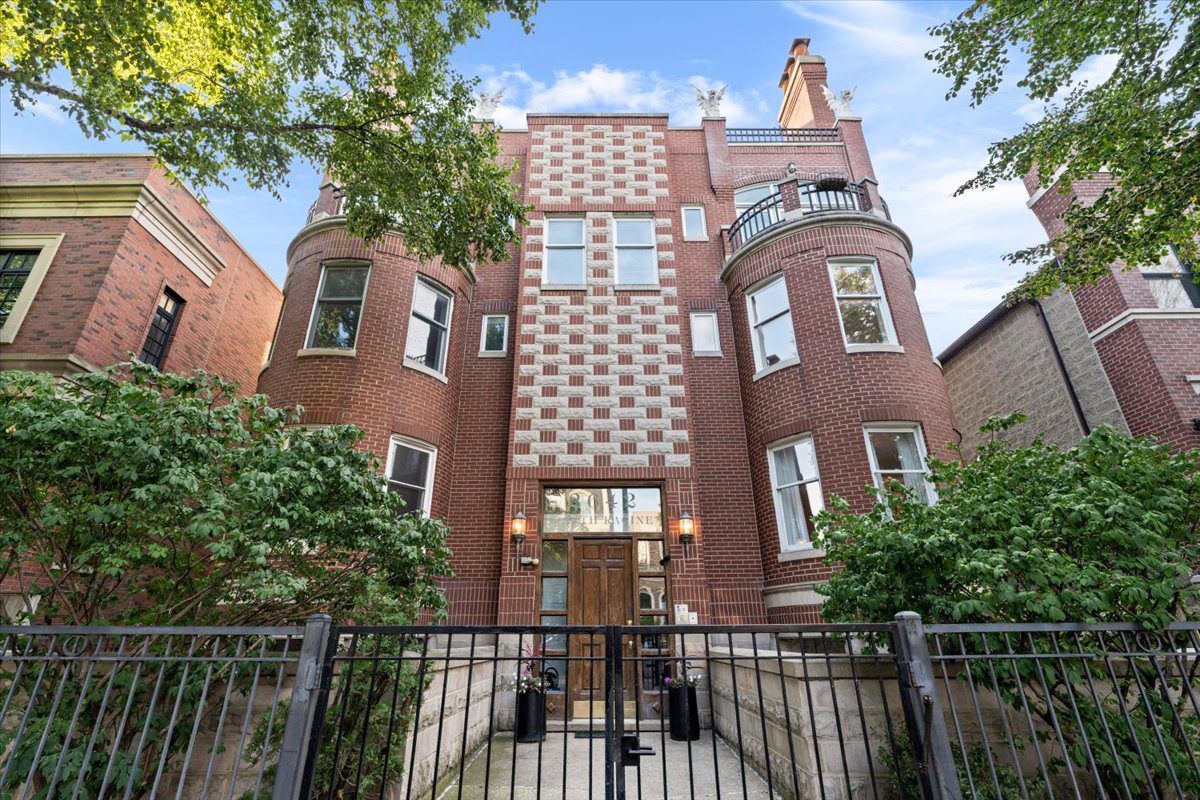 a view of a brick building next to a yard