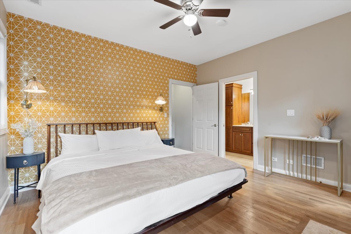 2642 North Racine Avenue, Unit 2N Chicago, IL 60614 - Photo 16 of 22 a bedroom with a large bed and a chandelier