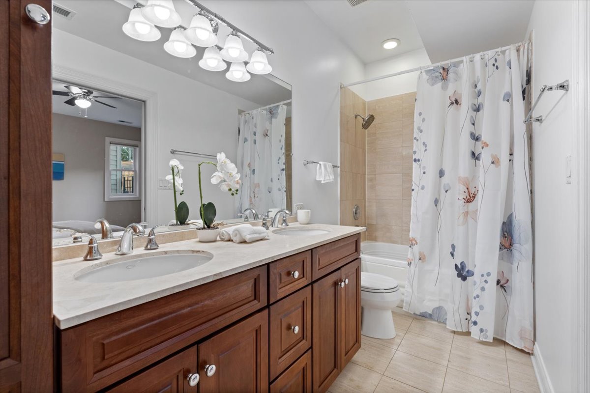 2642 North Racine Avenue, Unit 2N Chicago, IL 60614 - Photo 19 of 22 a bathroom with a double vanity sink mirror and toilet