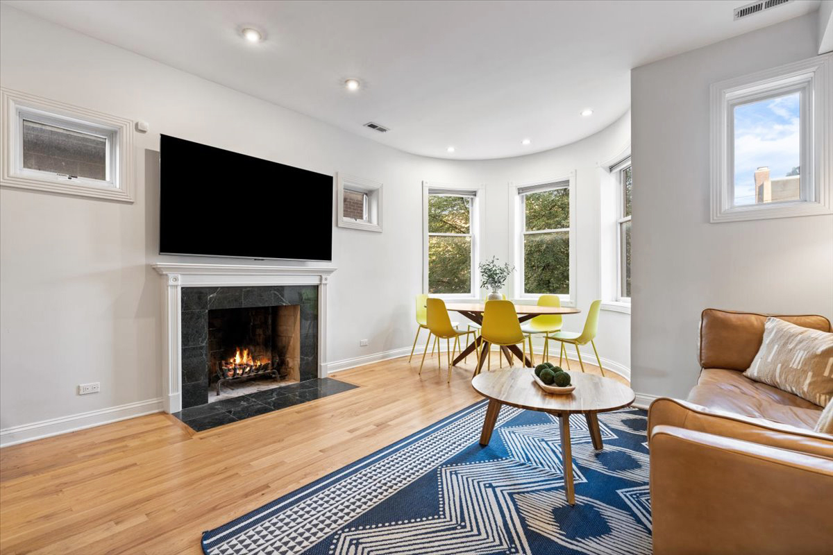 2642 North Racine Avenue, Unit 2N Chicago, IL 60614 - Photo 2 of 22 a living room with furniture a flat screen tv and a fireplace