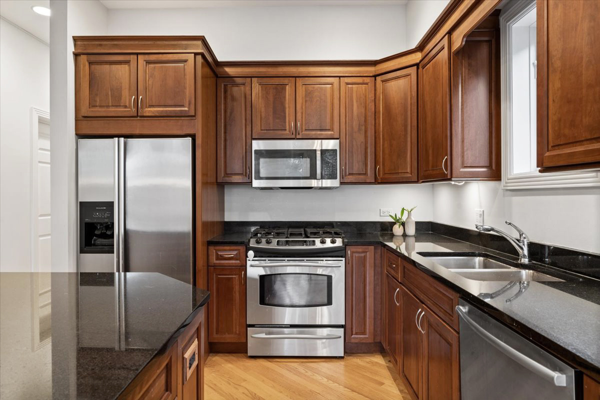 2642 North Racine Avenue, Unit 2N Chicago, IL 60614 - Photo 9 of 22 a kitchen with granite countertop a sink stove and refrigerator