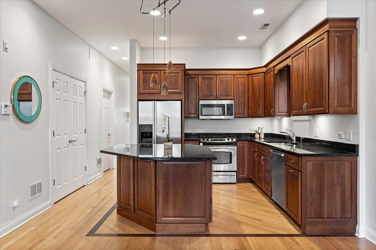 2642 North Racine Avenue, Unit 2N Chicago, IL 60614 - Photo 10 of 22 a large kitchen with stainless steel appliances granite countertop a stove a sink dishwasher and a refrigerator