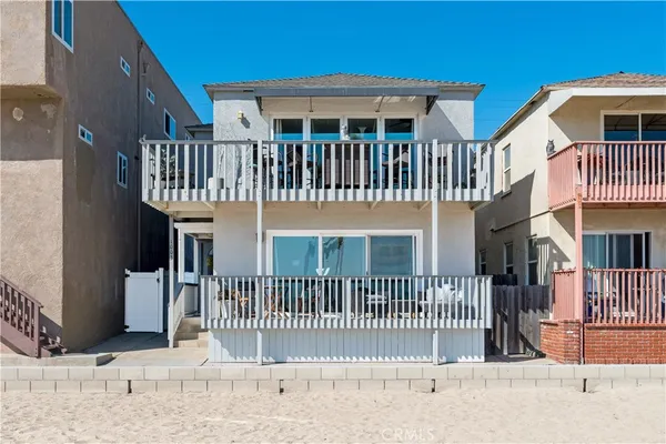 a front view of a house with iron fence