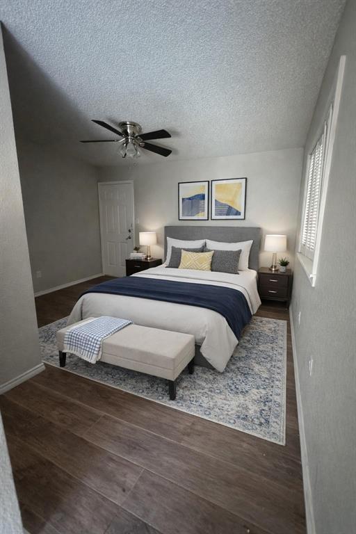 9823 Walnut Street, Unit L205 Dallas, TX 75243 - Photo 1 of 6 a bedroom with a bed rug and wooden floor