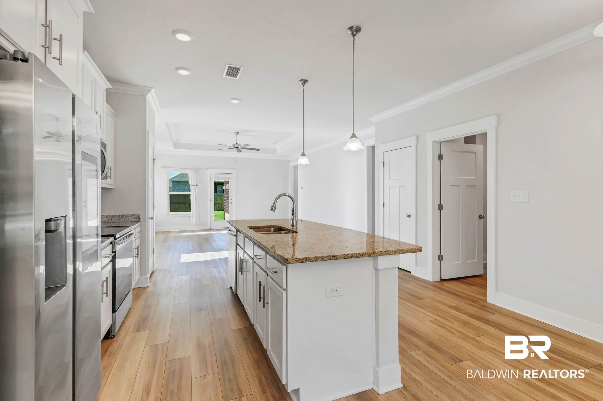 16461 Prado Loop Loxley, AL 36551 - Photo 7 of 78 Kitchen featuring stainless steel appliances, white cabinetry, hanging light fixtures, an island with sink, and recessed lighting