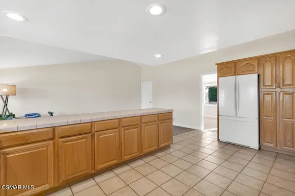 a kitchen with granite countertop cabinets and refrigerator