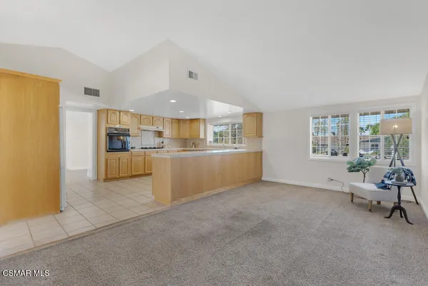 a view of kitchen and livingroom with furniture