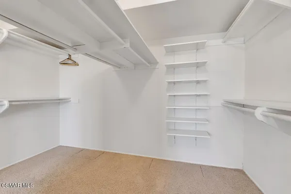 a view of a room with shelf on the wall