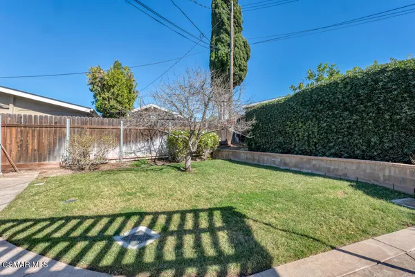 a view of backyard with swimming pool