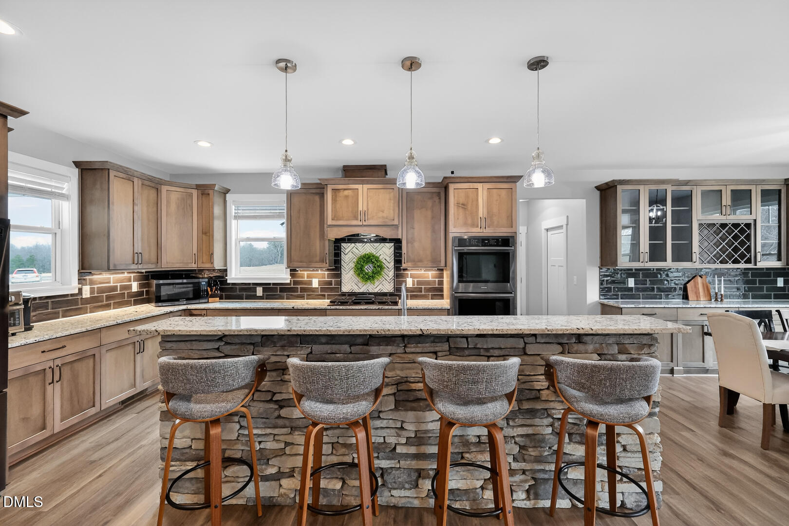 540 Pine Ridge Road Zebulon, NC 27597 - Photo 19 of 96 a kitchen with stainless steel appliances granite countertop a table chairs sink and cabinets
