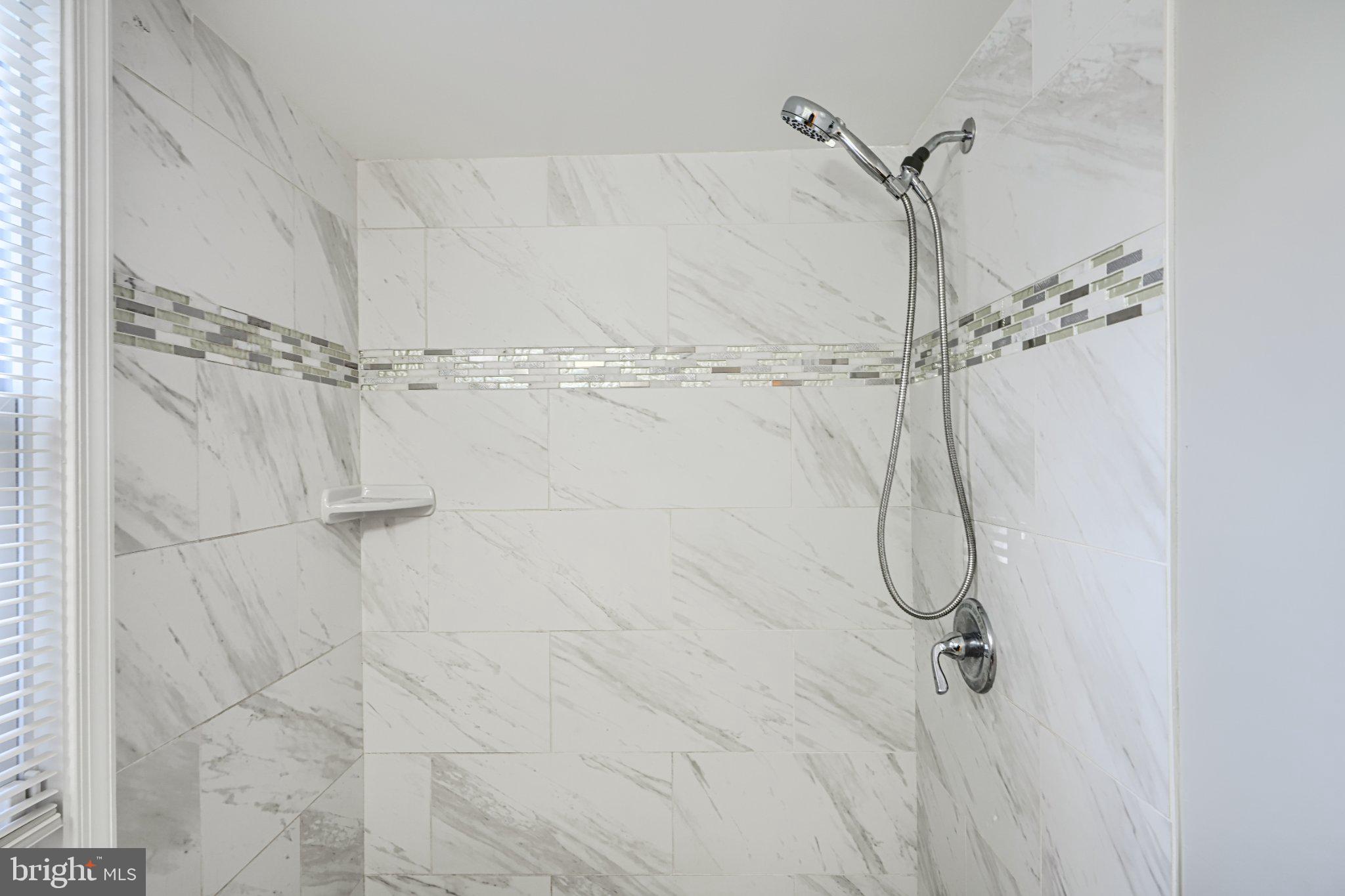 3414 Alto Road, Unit 1 Baltimore, MD 21216 - Photo 13 of 16 Sleek marble shower with modern accents.
