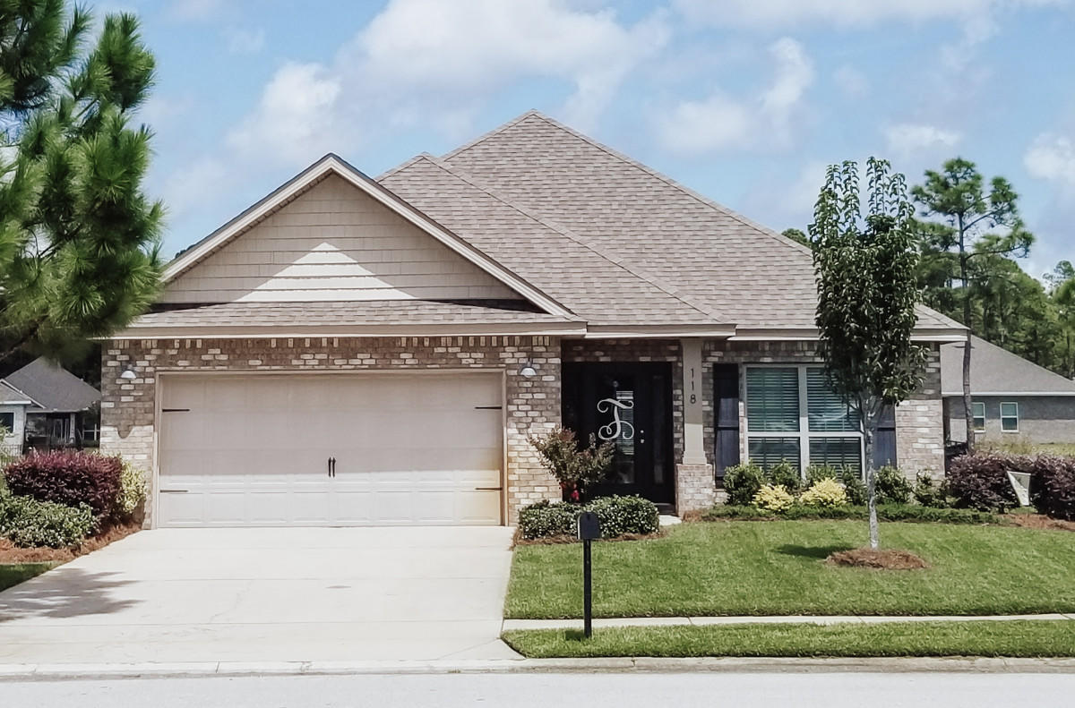 a front view of a house with garden