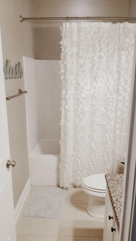 118 Pin Oak Loop Santa Rosa Beach, FL 32459 - Photo 7 of 15 a bathroom with a toilet and a shower curtain