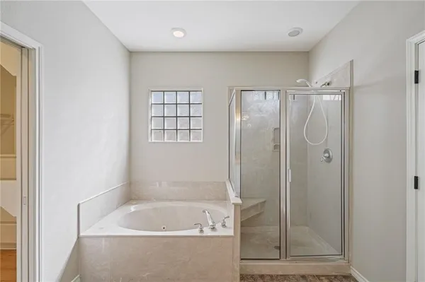 a bathroom with a bathtub and a shower