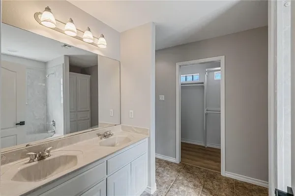 a bathroom with a sink a shower and a mirror