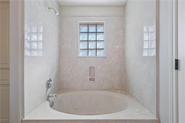 a white bath tub sitting next to a window