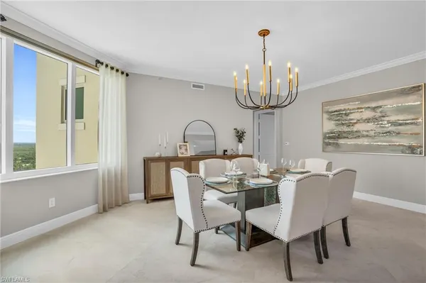 a view of a dining room with furniture wooden floor and chandelier