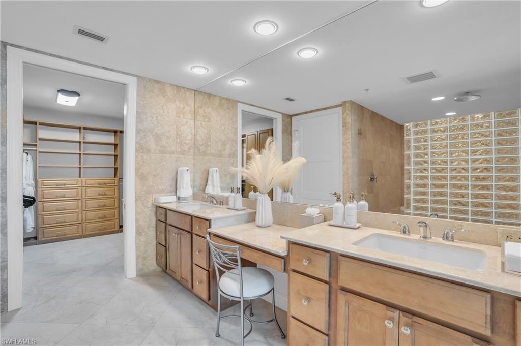 265 Indies Way, Unit 1402 Naples, FL 34110 - Photo 28 of 44 Bathroom with tile flooring, tile walls, and vanity