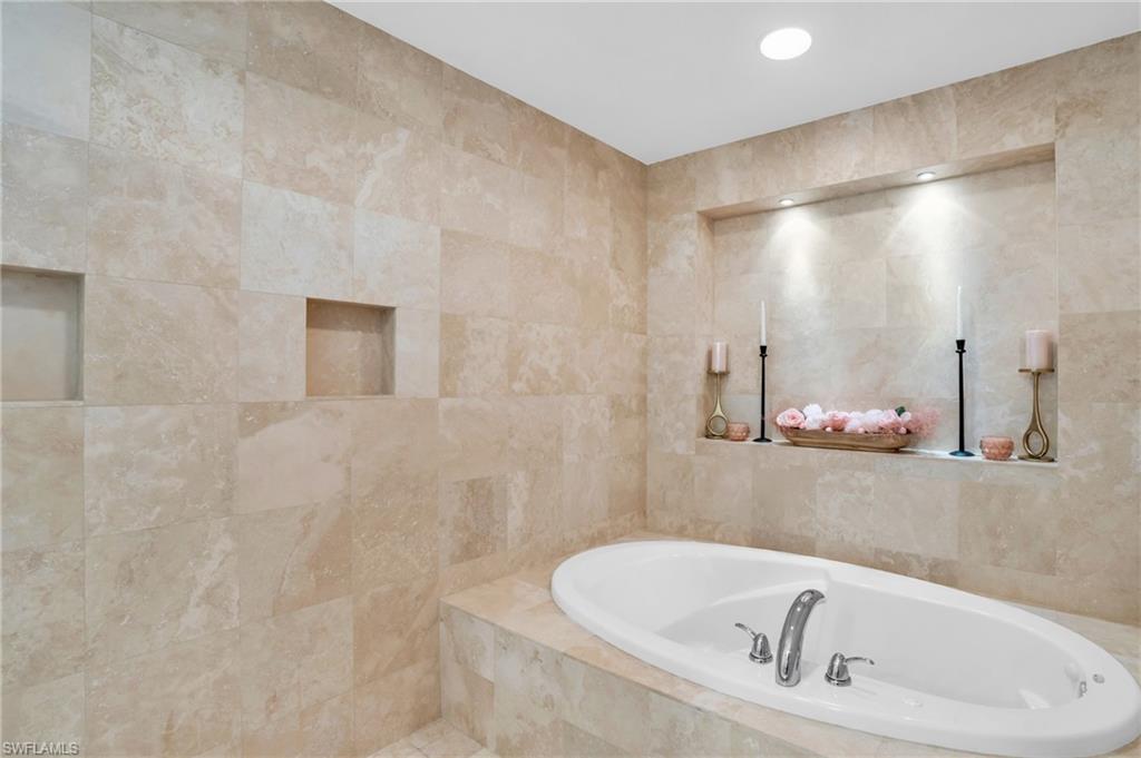 265 Indies Way, Unit 1402 Naples, FL 34110 - Photo 29 of 44 Bathroom featuring tiled bath and tile walls