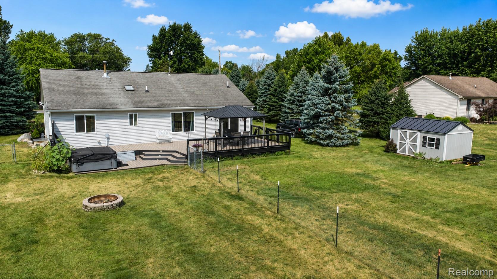 13063 Seymour Road Gaines, MI 48436 - Photo 27 of 29 Expansive backyard with a multi-level deck, gazebo, and fire pit