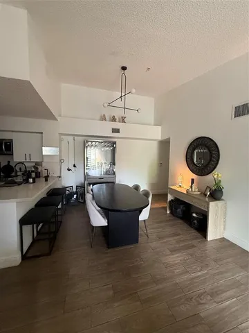 a living room with furniture a flat screen tv and a window