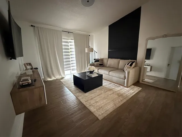 a kitchen with a sink stainless steel appliances and white cabinets