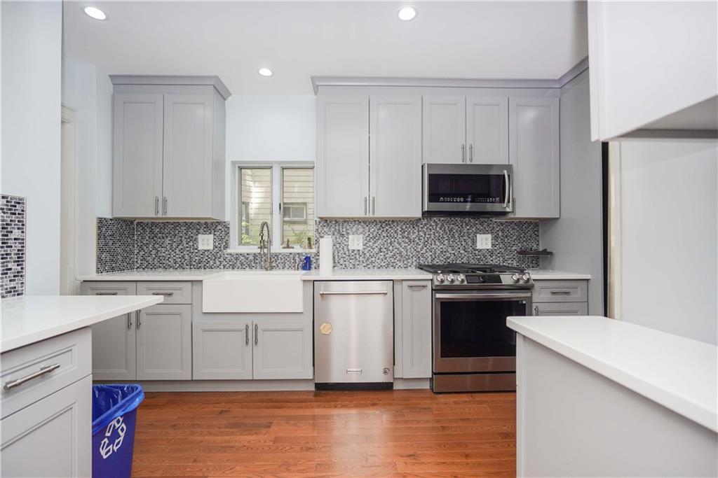 793 Westminster Road Brooklyn, NY 11230 - Photo 11 of 47 a kitchen with granite countertop a stove a sink and a microwave
