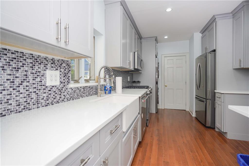 793 Westminster Road Brooklyn, NY 11230 - Photo 13 of 47 a kitchen with a sink a refrigerator and a stove top oven