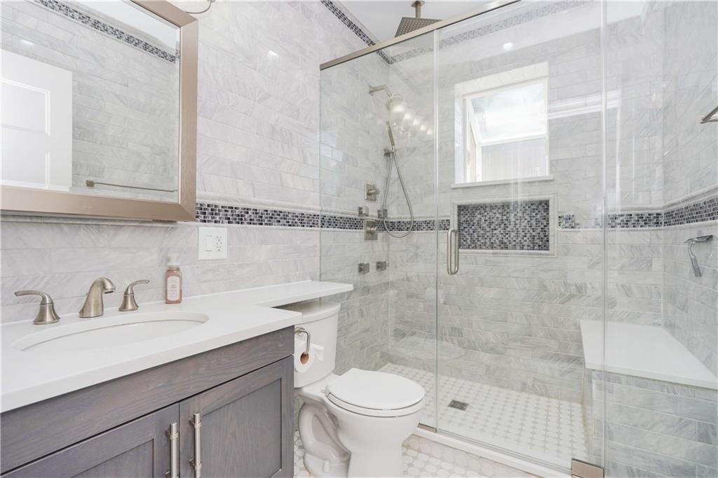 793 Westminster Road Brooklyn, NY 11230 - Photo 15 of 47 a bathroom with a sink toilet a mirror and shower