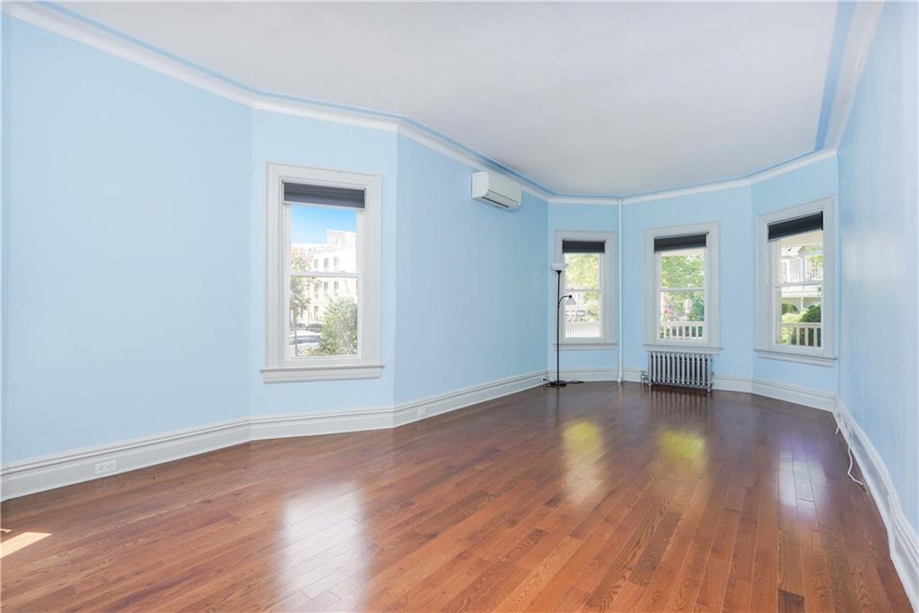 793 Westminster Road Brooklyn, NY 11230 - Photo 18 of 47 an empty room with wooden floor and windows