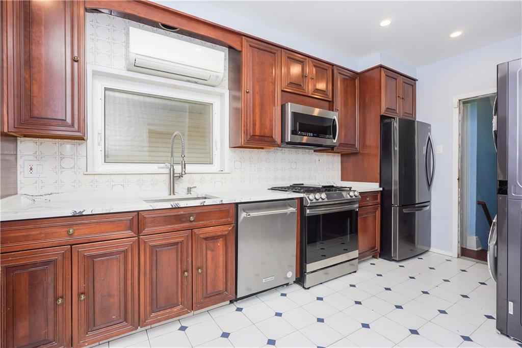 793 Westminster Road Brooklyn, NY 11230 - Photo 23 of 47 a kitchen with stainless steel appliances a refrigerator sink and microwave