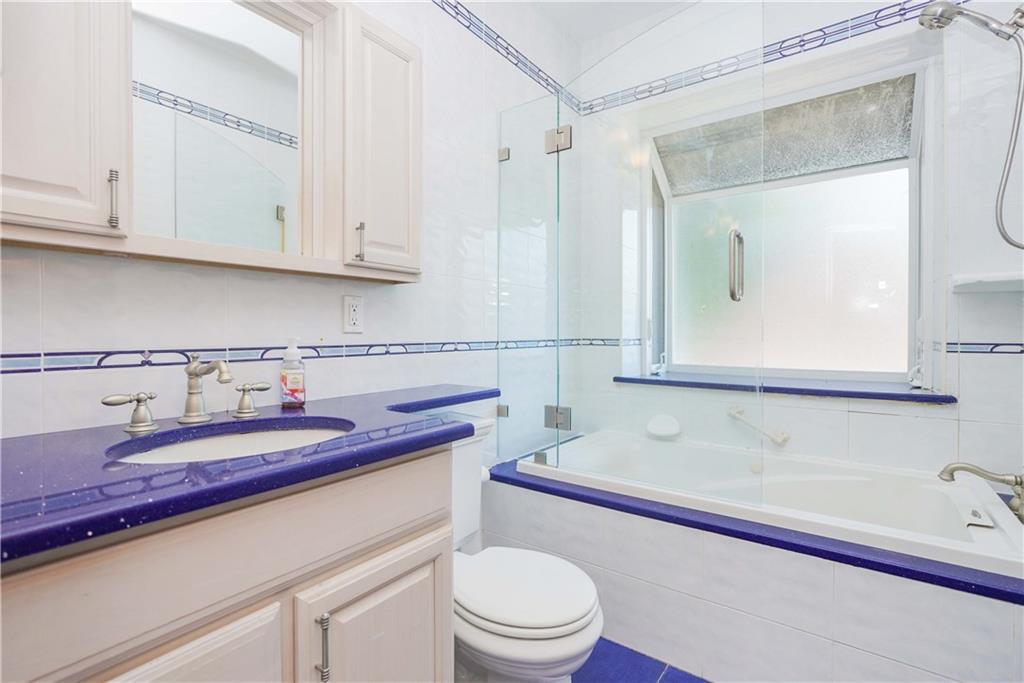 793 Westminster Road Brooklyn, NY 11230 - Photo 39 of 47 a bathroom with a granite countertop toilet sink and mirror