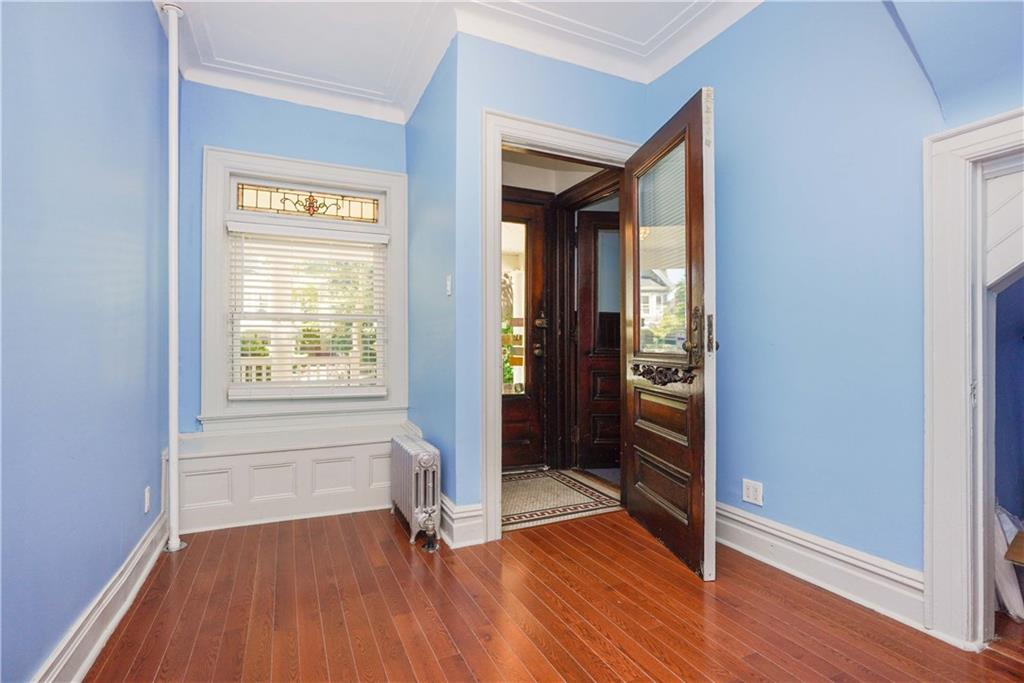 793 Westminster Road Brooklyn, NY 11230 - Photo 9 of 47 an empty room with wooden floor and windows