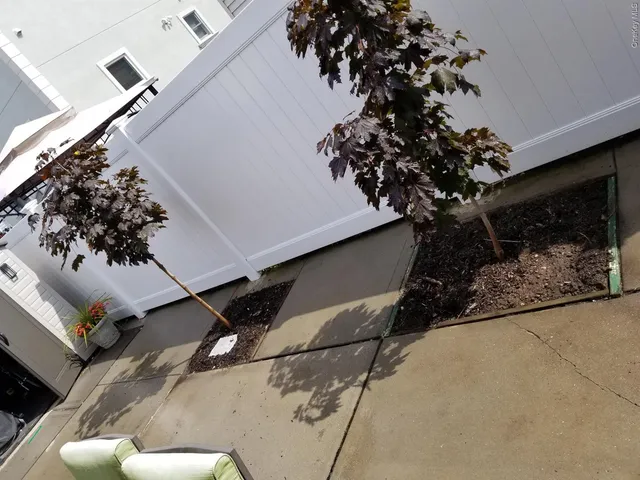 a view of a pathway with flower pots