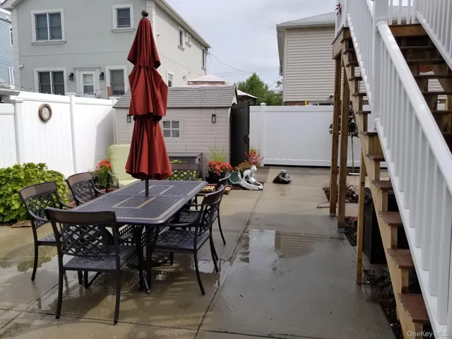 a view of staircase with railing and a chandelier