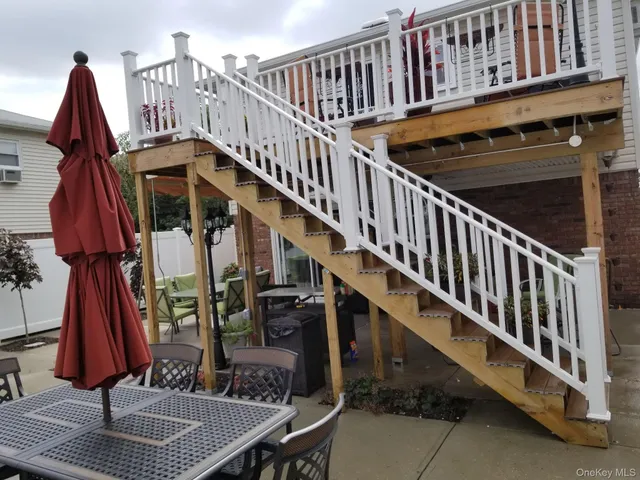 a view of a chairs and table in the balcony