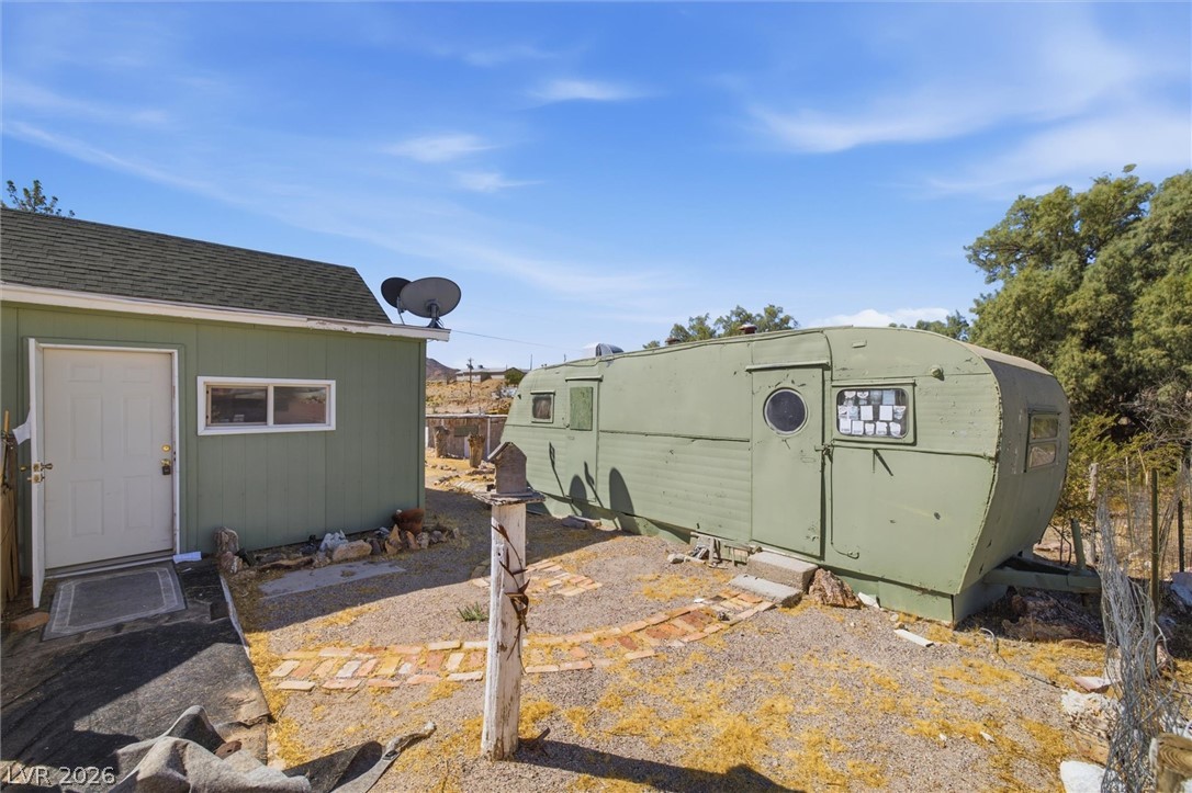 405 Main Street Beatty, NV 89003 - Photo 3 of 28 A charming green shed and matching vintage trailer offer unique desert living.