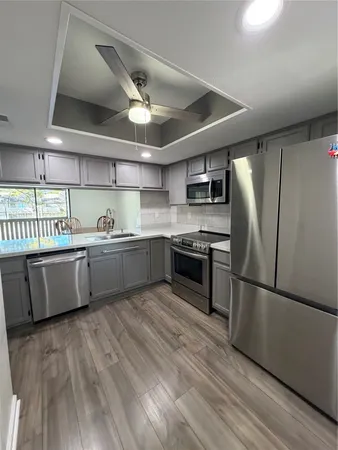 a kitchen with stainless steel appliances a sink and a stove