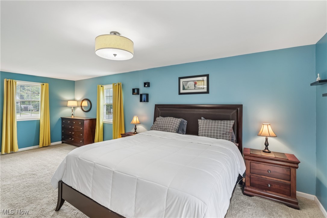 520 East Caston Road Uniontown, OH 44685 - Photo 18 of 47 Primary bedroom with a balcony and carpet flooring
