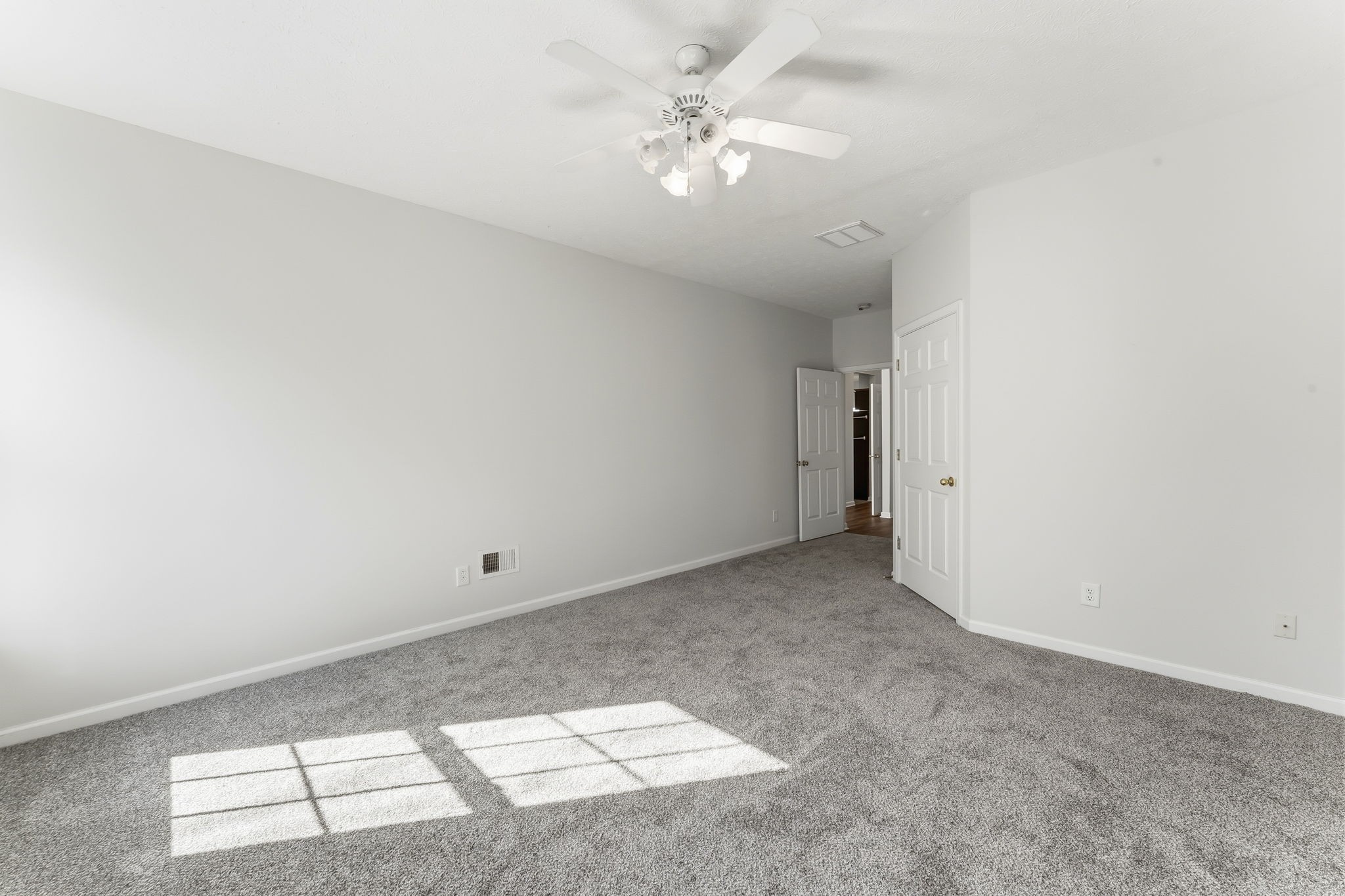 3401 Anderson Road, Unit 80 Antioch, TN 37013 - Photo 22 of 39 an empty room with a chandelier fan and windows