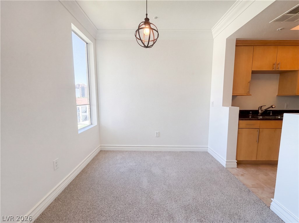 230 East Flamingo Road, Unit 320 Las Vegas, NV 89169 - Photo 7 of 19 A versatile living space with a distinct kitchen area, bathed in natural light from the window.