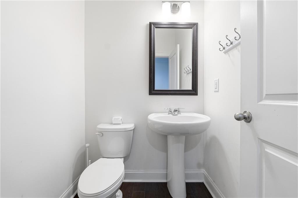 3425 Hardy Street Cumming, GA 30041 - Photo 17 of 25 a bathroom with a toilet a sink and mirror