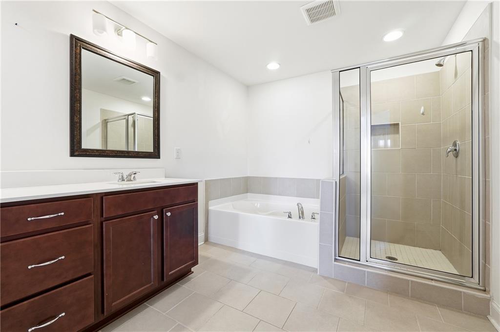 3425 Hardy Street Cumming, GA 30041 - Photo 19 of 25 a bathroom with a bathtub shower sink vanity and mirror