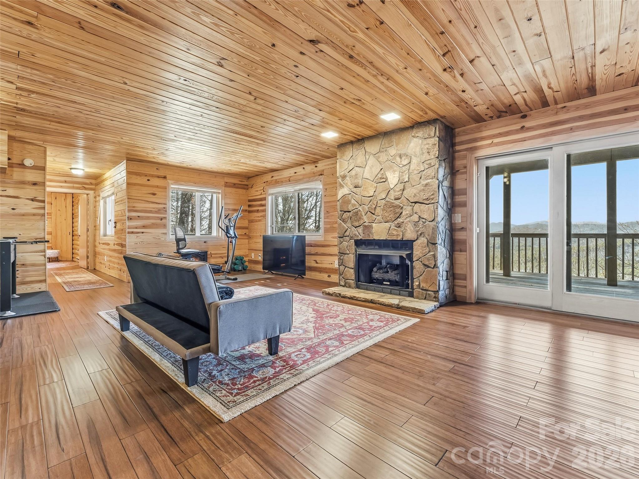 101 Ruffed Grouse Road Brevard, NC 28712 - Photo 32 of 38 a living room with furniture wooden floor and a fireplace