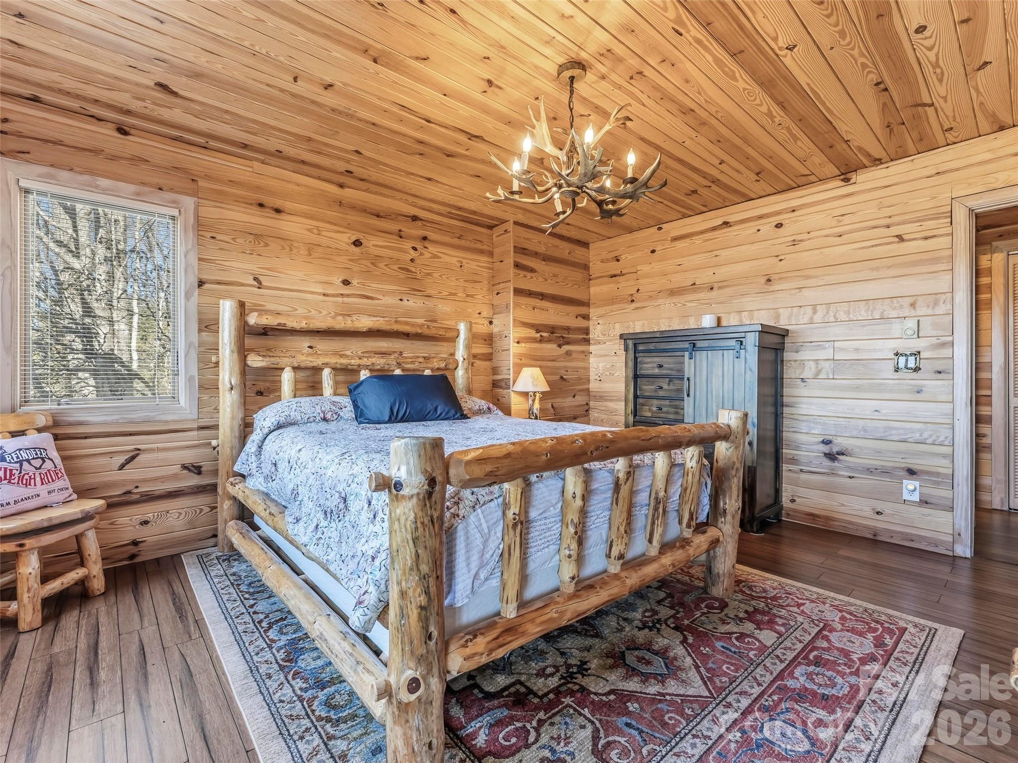 101 Ruffed Grouse Road Brevard, NC 28712 - Photo 36 of 38 a bedroom with a bed and wooden floor