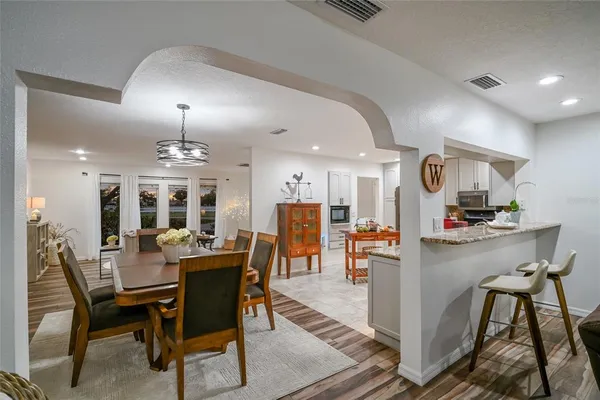 a kitchen with granite countertop a sink a stove and cabinets