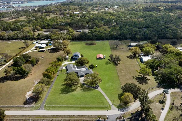a front view of a house with a yard and outdoor seating